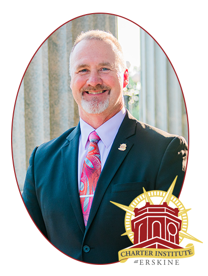 a man in a suit and tie with the charter institute logo