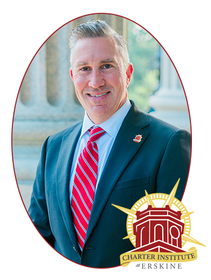 a group of people standing on a stage in front of a charter institute at erskine backdrop